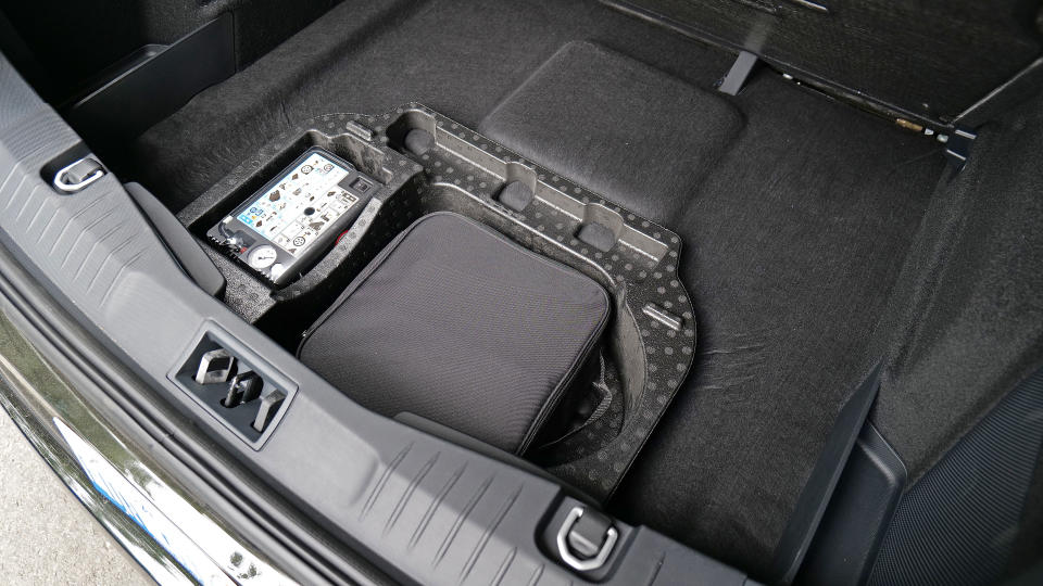 The Mustang Mach-E comes with a bundled mobile charger and a handy cubby for stashing it beneath the rear cargo area. 