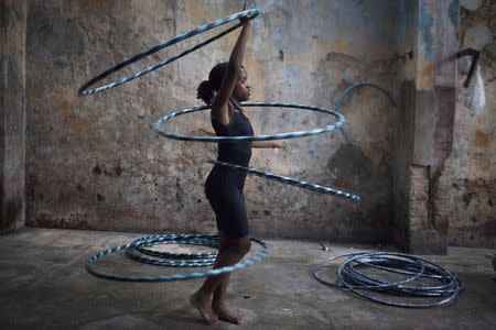 A girl performs with hoops during a training session at a circus school in Havana, September 26, 2014. REUTERS/Alexandre Meneghini