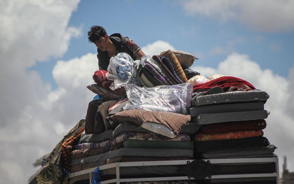 Palestinians flee following Israeli army orders to evacuate the eastern side of the city, ahead of military operations in Rafah, Gaza, on Monday, May 6, 2024. Israel rejected a statement from Hamas that it had accepted a cease-fire proposal to end the fighting in Gaza, saying its forces would continue their operation in Rafah to eradicate the Palestinian militant group. Photographer: Ahmad Salem/Bloomberg