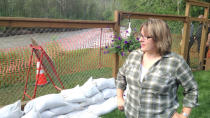 Fort McMurray resident Kelly Tuohey worries her property may soon slide into the Hangingstone River, now surging at historically high levels.