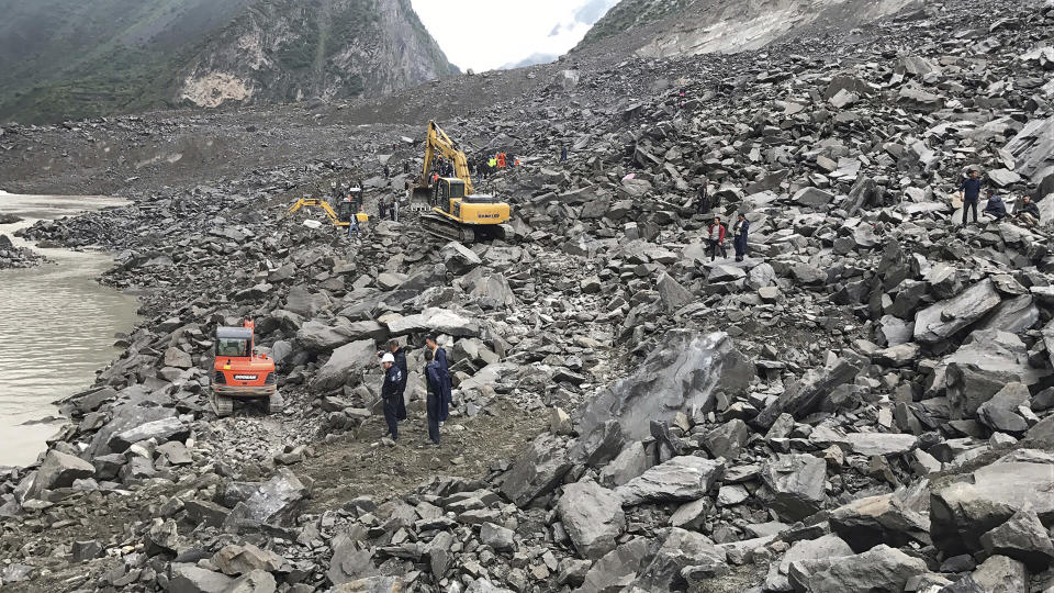 <p> Emergency personnel and earthmoving equipment work at the site of a massive landslide in Xinmo village in Maoxian County in southwestern China's Sichuan Province, Saturday, June 24, 2017. Dozens of people are feared buried by a landslide that unleashed huge rocks and a mass of earth that crashed into their homes in southwestern China early Saturday, a county government said. (Chinatopix via AP) </p>
