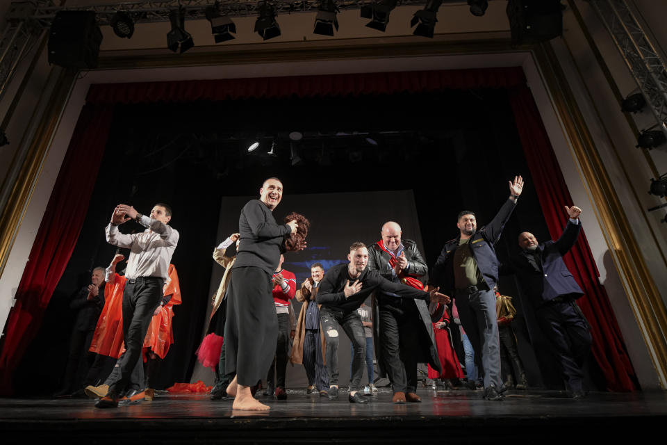 Inmates salute the public after performing in the State of Siege, by French author Albert Camus, a play describing the arrival of plague in Spain which brings a totalitarian regime to power, at the Nottara Theatre in Bucharest, Romania, Wednesday, Nov. 24, 2021. Performing on the main stage of the reputed Nottara Theatre downtown Bucharest is a dream opportunity for any Romanian aspiring artist – getting to do that as a convicted inmate is a breakthrough.(AP Photo/Andreea Alexandru)