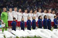 Denmark's players sing the national anthem before the World Cup group D soccer match between France and Denmark, at the Stadium 974 in Doha, Qatar, Saturday, Nov. 26, 2022. (AP Photo/Martin Meisner)