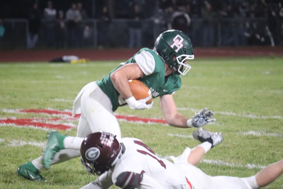 Oak Harbor's Hayden Buhro slips a tackle on the way to a touchdown.