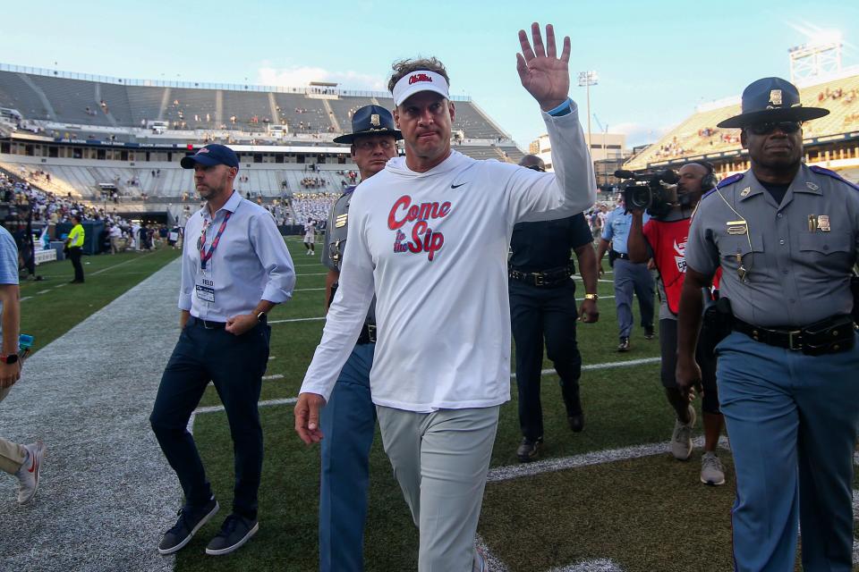 Mississippi coach Lane Kiffin waves to fans after his team's defeat of Georgia Tech at Bobby Dodd Stadium.