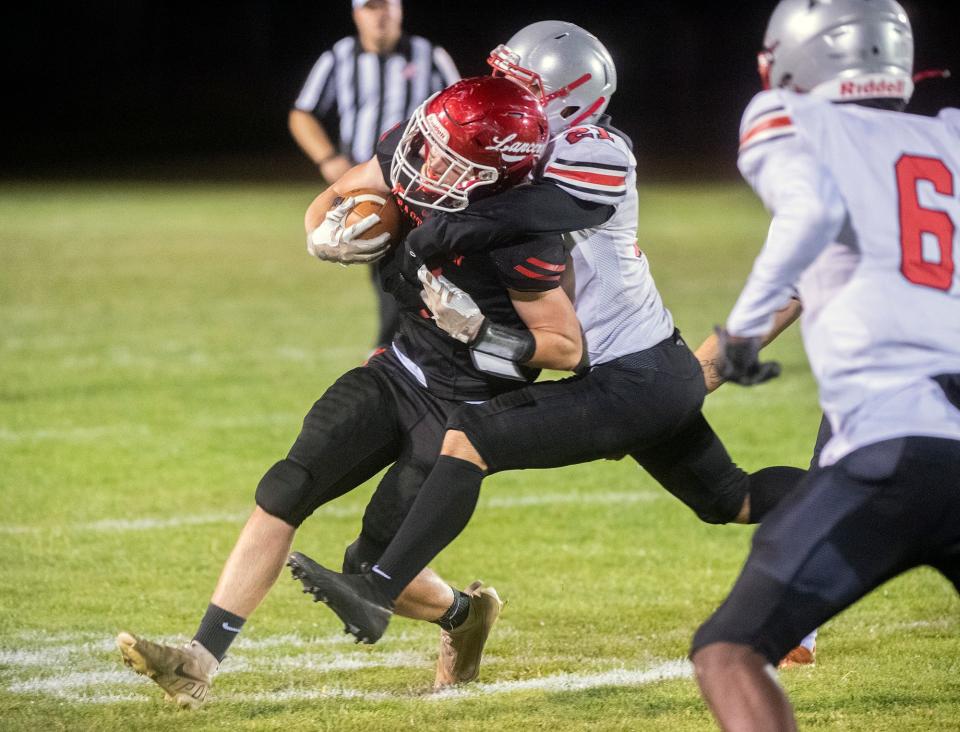 East Union's Carson Sanders (9), left, is tackled by Lincoln's Keyvhun Rigmaden (21) during a varsity football game at East Union in Manteca on Friday, Sept. 23, 2022.