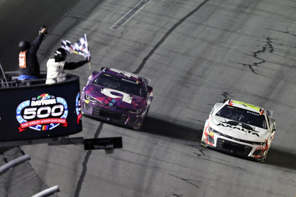 William Byron, right, takes the checkered flag just ahead of Alex Bowman to win the NASCAR Daytona 500 auto race at Daytona International Speedway, Monday, Feb. 19, 2024, in Daytona Beach, Fla. (AP Photo/David Graham)