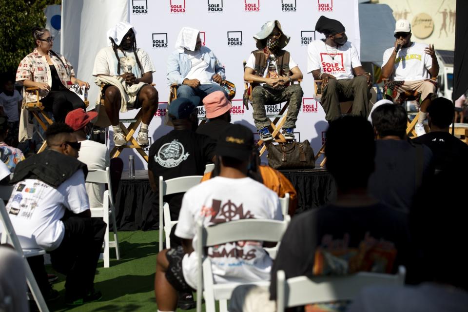 Guests sit on a panel