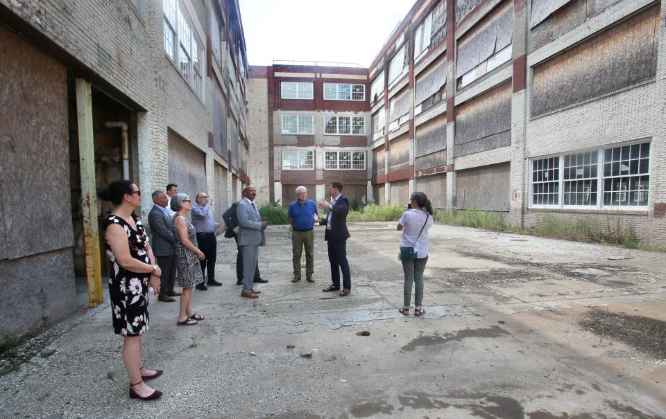 Jeff Martin, second from right, senior vice president of development at Industrial Commercial Properties, leads a tour of the Hoover District in North Canton.