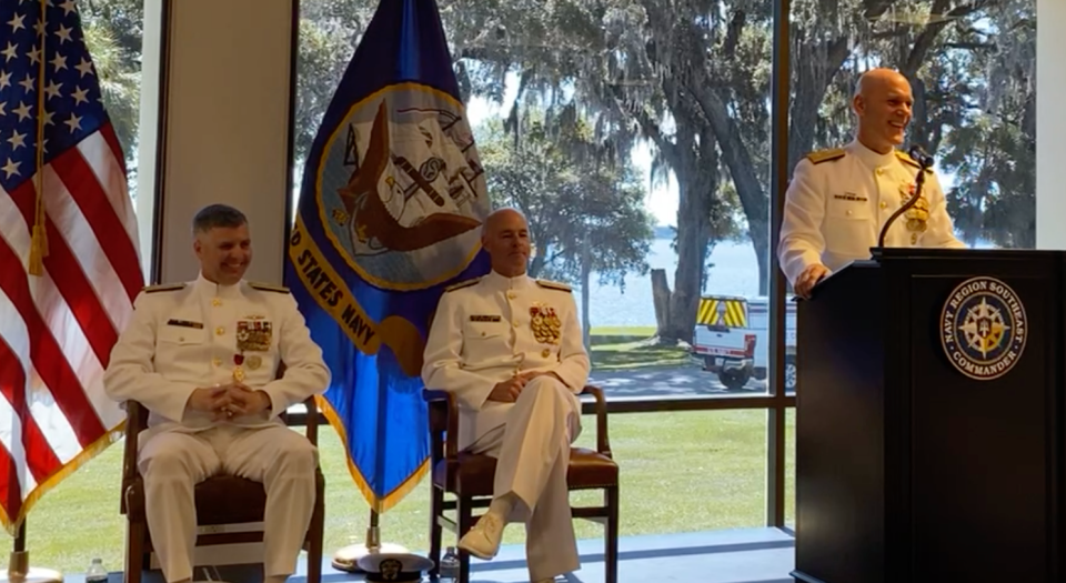 Rear Adm. John Hewitt, right, incoming commander of Navy Region Southeast, shares a moment of levity with the crowd and the man he's replacing, Rear Adm. Ian Johnson, left, and Vice Adm. Christopher "Scotty" Gray. The change of command ceremony took place Thursday at Naval Air Station Jacksonville.