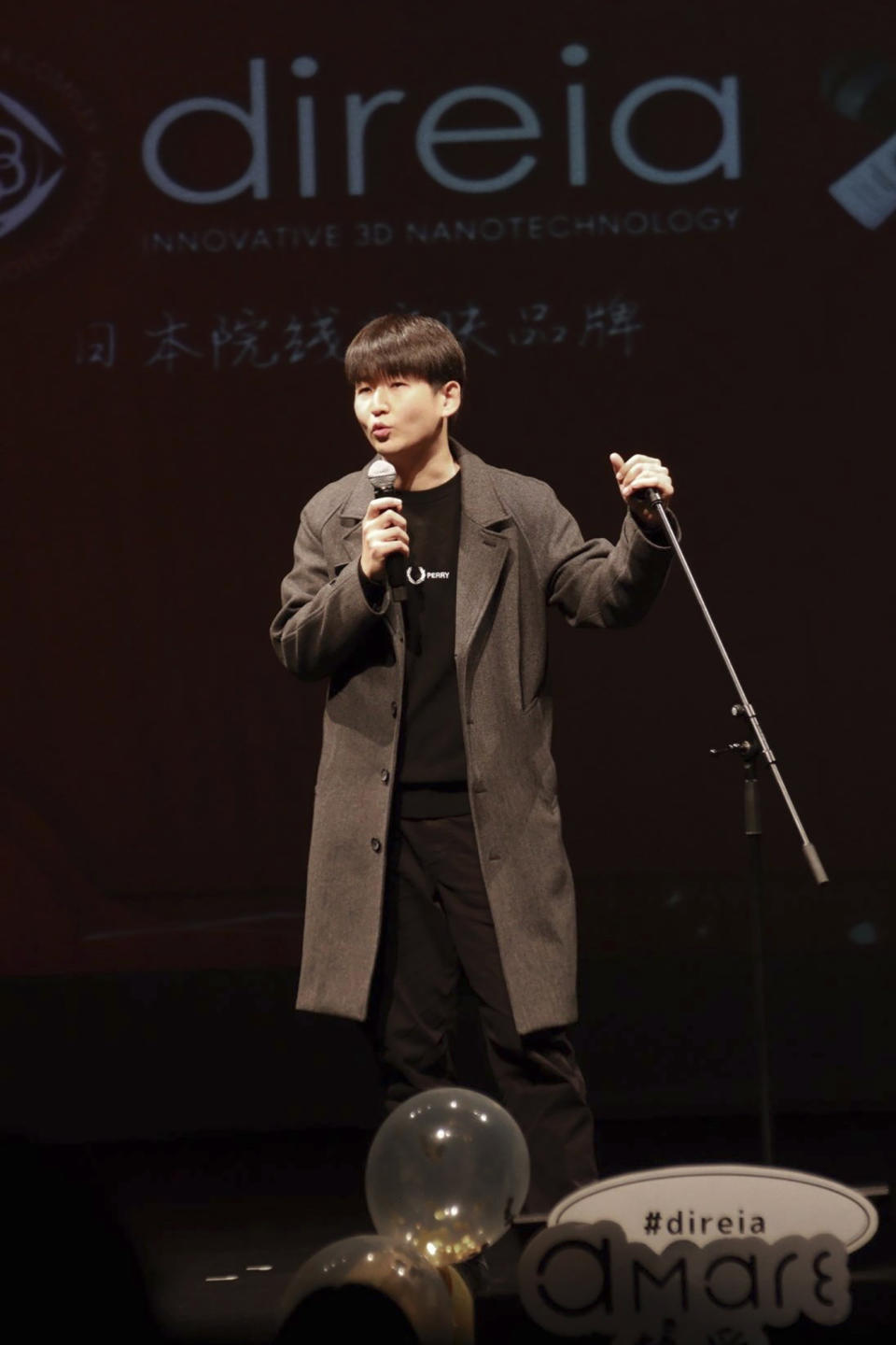 In this photo provided by Guo Jia, a businessman who runs a comedy club in Tokyo, Guo performs standup in Tokyo, Monday, Jan. 9, 2023. (Courtesy of Guo Jia via AP)