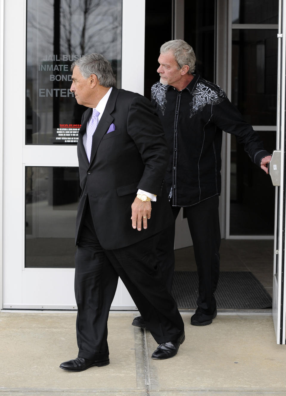 Attorney James Voyles, left and Indianapolis Colts owner Jim Irsay leave the Hamilton County Jail in Indianapolis, Monday, March 17, 2014. Irsay was released from jail Monday after being held overnight following a traffic stop in which police said he failed sobriety tests and had multiple prescription drugs inside his vehicle. Irsay was pulled over late Sunday after he was spotted driving slowly near his home in suburban Carmel, stopping in the roadway and failing to use a turn signal. (AP Photo/Alan Petersime)
