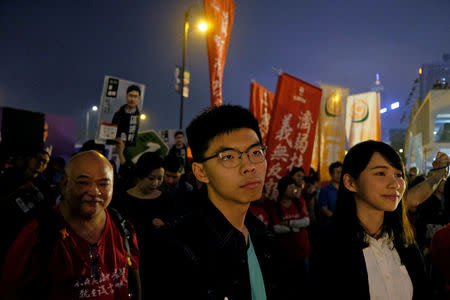 Pro-democracy activists Joshua Wong and Agnes Chow attend an election campaign at the financial Central district in Hong Kong, China March 3, 2018. Picture taken March 3, 2018. REUTERS/Bobby Yip