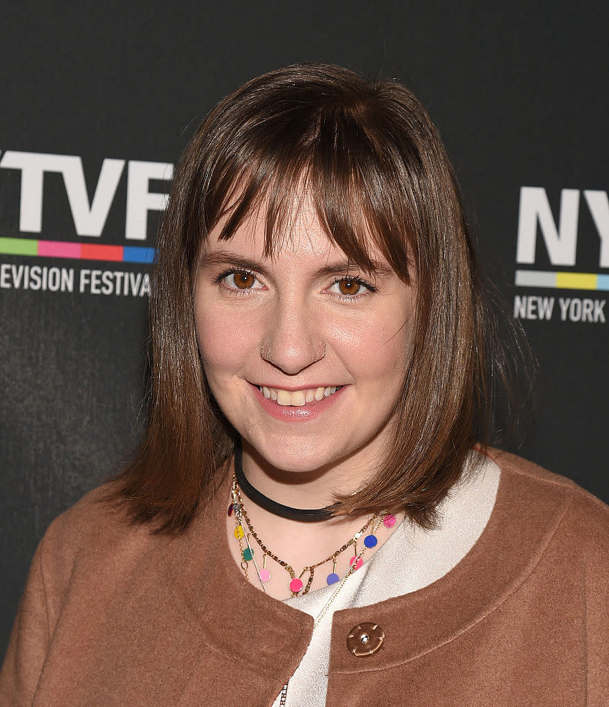 Lena Dunham paired a long brown coat with fluffy cheetah stilettos and it is giving us LIFE