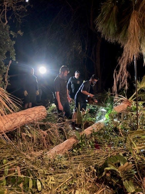 A group of men drove up from Naples with heavy equipment to help clean up shingles and other yard debris at Gloria Crosby's home in Bokeelia after Hurricane Ian.