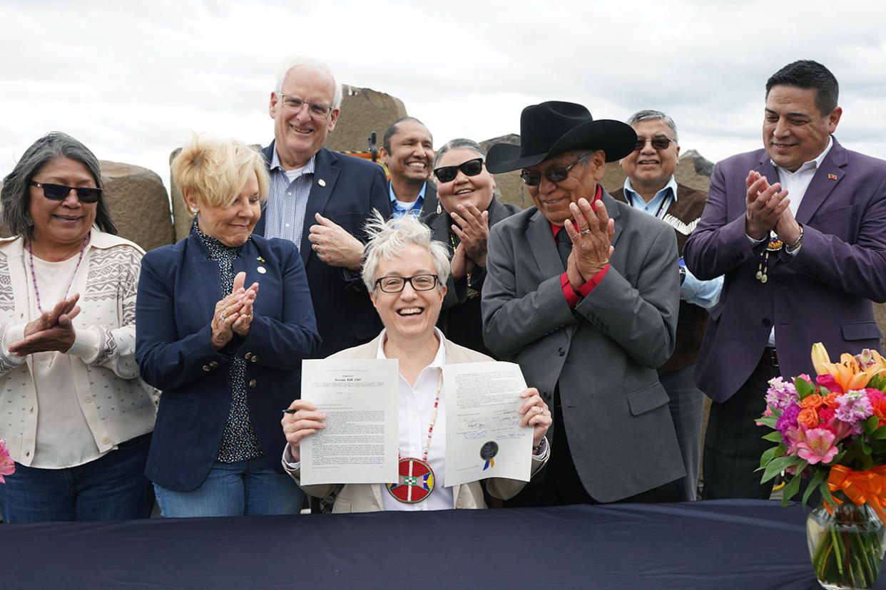 Oregon Gov. Tina Kotek holds up a ceremonially signed copy of Senate Bill 1567 while members of the Confederated Tribes of the Umatilla Indian Reservation Board of Trustees and elected state officials applaud on Thursday, April 25, outside of the Nixyáawii Governance Center in Mission. SB 1567 or the Walla Wall 2050 Strategic Plan calls for cooperative water management between Oregon and Washington in the Walla Walla Basin to help restore salmon. Standing from left to right are Board Member at Large Lisa Ganuelas, Rep. Bobbie Levy, Sen. Bill Hansell, Board Members at Large Steven Hart and Corinne Sams, Chairman Gary I. Burke, General Council Chairman Alan Crawford and Board Vice Chairman Aaron Ashley. (Photo/Lee Gavin - CTUIR)   