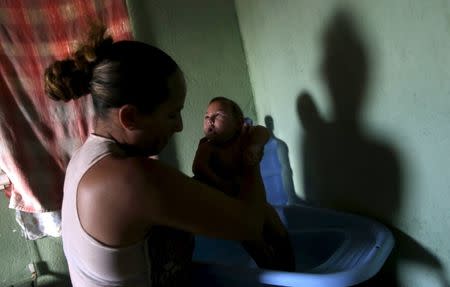Josemary da Silva, 34, bathes Gilberto, five months old, her fifth child and born with microcephaly, at her house in Algodao de Jandaira, Brazil, February 17, 2016. REUTERS/Ricardo Moraes
