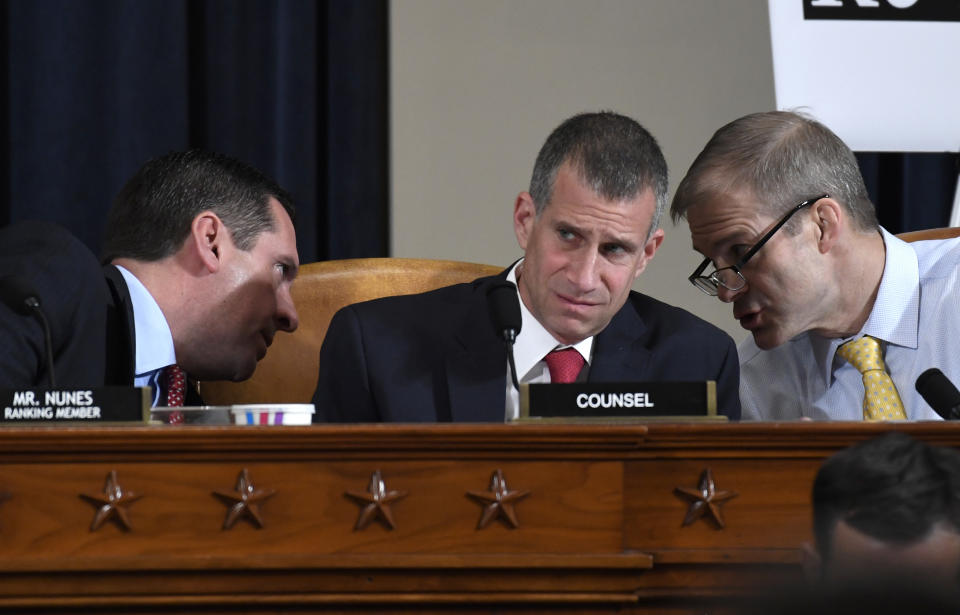 Ranking member Rep. Devin Nunes, R-Calif., talks to Rep. Jim Jordan, R-Ohio, right, as Steve Castor, Republican staff attorney for the House Oversight Committee, center, listens during the House Intelligence Committee on Capitol Hill in Washington, Wednesday, Nov. 13, 2019, in the first public impeachment hearing of President Donald Trump's efforts to tie U.S. aid for Ukraine to investigations of his political opponents. (AP Photo/Susan Walsh)