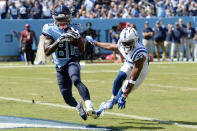 Tennessee Titans wide receiver Chester Rogers (80) catches a touchdown pass ahead of Indianapolis Colts cornerback Kenny Moore II (23) in the first half of an NFL football game Sunday, Sept. 26, 2021, in Nashville, Tenn. (AP Photo/Mark Zaleski)