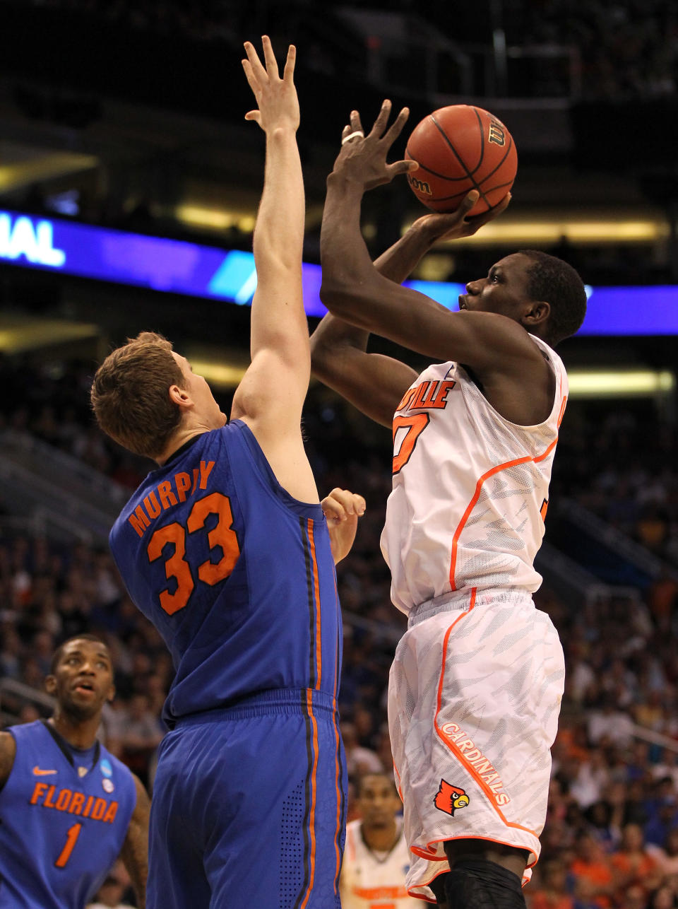 PHOENIX, AZ - MARCH 24: Gorgui Dieng #10 of the Louisville Cardinals shoots over Erik Murphy #33 of the Florida Gators in the first half during the 2012 NCAA Men's Basketball West Regional Final at US Airways Center on March 24, 2012 in Phoenix, Arizona. (Photo by Jamie Squire/Getty Images)