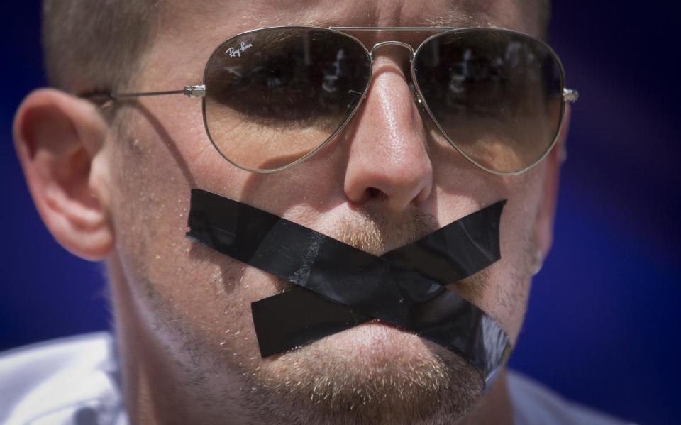 A members of the foreign media wears black tape across his mouth, to signify the silencing of the media, at a demonstration by Kenyan and Nairobi-based foreign media calling for the release in Egypt of detained Al Jazeera journalist Peter Greste and his colleagues, in Nairobi, Kenya Thursday, Feb. 27, 2014. The protest, part of a global day of action in support of press freedom, called for all journalists jailed in Egypt to be freed but focused attention in particular on Greste, a Nairobi-based correspondent for Al Jazeera who has been in custody in Egypt since Dec. 29, 2013. (AP Photo/Ben Curtis)