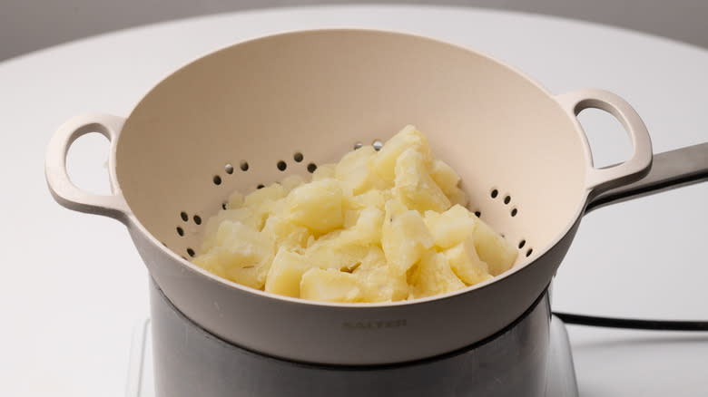 draining potatoes in a colander 