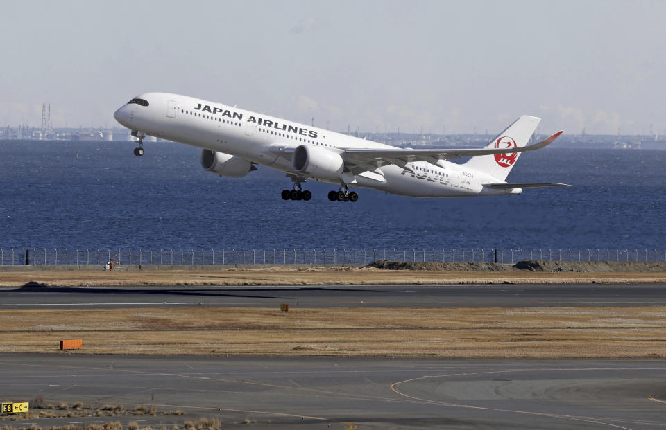 A Japan Airlines plane takes off from the runway where a plane collision took place, at Haneda airport in Tokyo Monday, Jan. 8, 2024. Tokyo’s Haneda airport is almost back to its normal operation Monday as it reopened the runway a week after a fatal collision between a Japan Airlines airliner and a coast guard aircraft seen to have been caused by human error. (Kyodo News via AP)