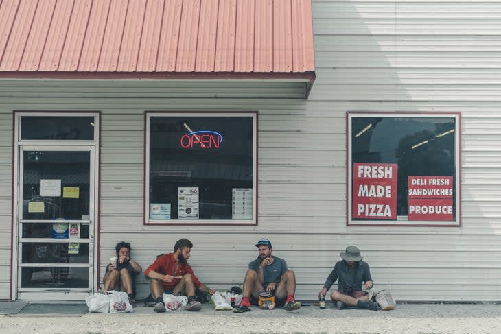 Hikers in front of a grocery store