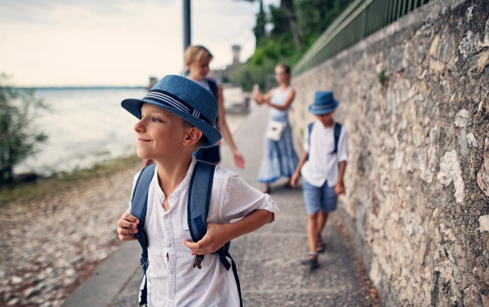 Family walking along a path on Lake Garda in Italy