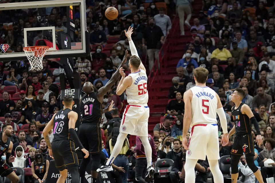 Los Angeles Clippers center Isaiah Hartenstein (55) shoots over Miami Heat center Dewayne Dedmon (21) during the first half of an NBA basketball game, Friday, Jan. 28, 2022, in Miami. (AP Photo/Lynne Sladky)