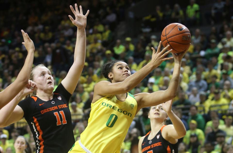 Oregon's Satou Sabally, center, and Oregon State's Mikayla Pivec will battle again this weekend. (AP Photo/Chris Pietsch)