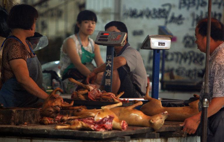 People sell dog meat in a market in Yulin, south China's Guangxi region, on June 18, 2014