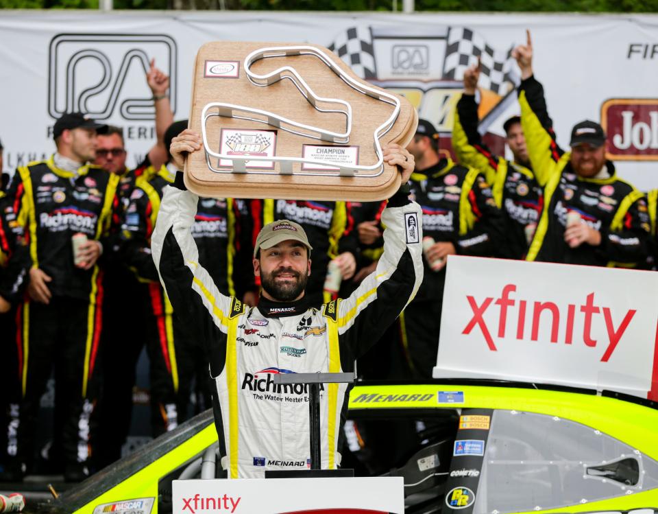 Paul Menard holds up the trophy after wining the 2015 Road America 180.