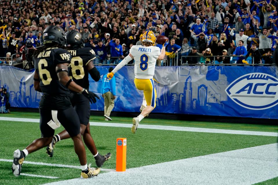 Pittsburgh quarterback Kenny Pickett celebrates after scoring against Wake Forest during the first half of the Atlantic Coast Conference championship.