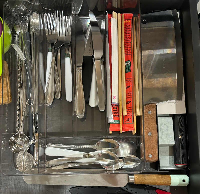 Kitchen with acrylic silverware storage.