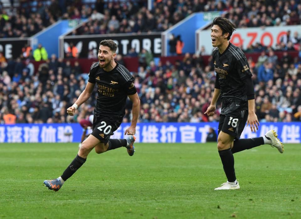 Jorginho and Takehiro Tomiyasu celebrate the third Arsenal goal, an own goal scored by Aston Villa goalkeeper Emi Martinez during the Premier League match (Arsenal FC via Getty Images)