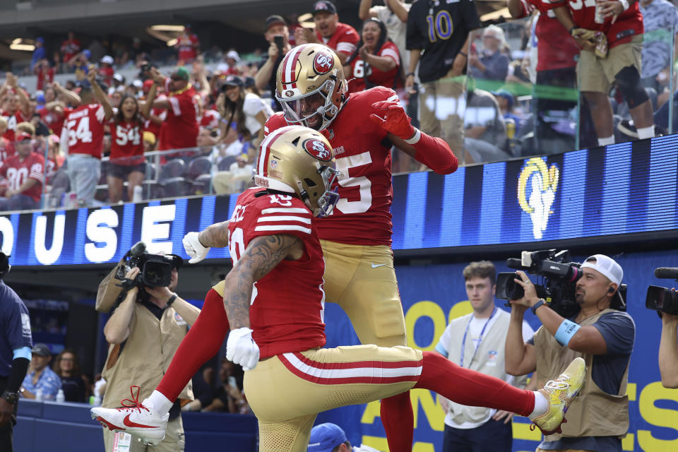 San Francisco 49ers wide receiver Jauan Jennings, top middle, is congratulated by wide receiver Ronnie Bell after scoring against the Los Angeles Rams during the second half of an NFL football game, Sunday, Sept. 22, 2024, in Inglewood, Calif. (AP Photo/Ryan Sun)