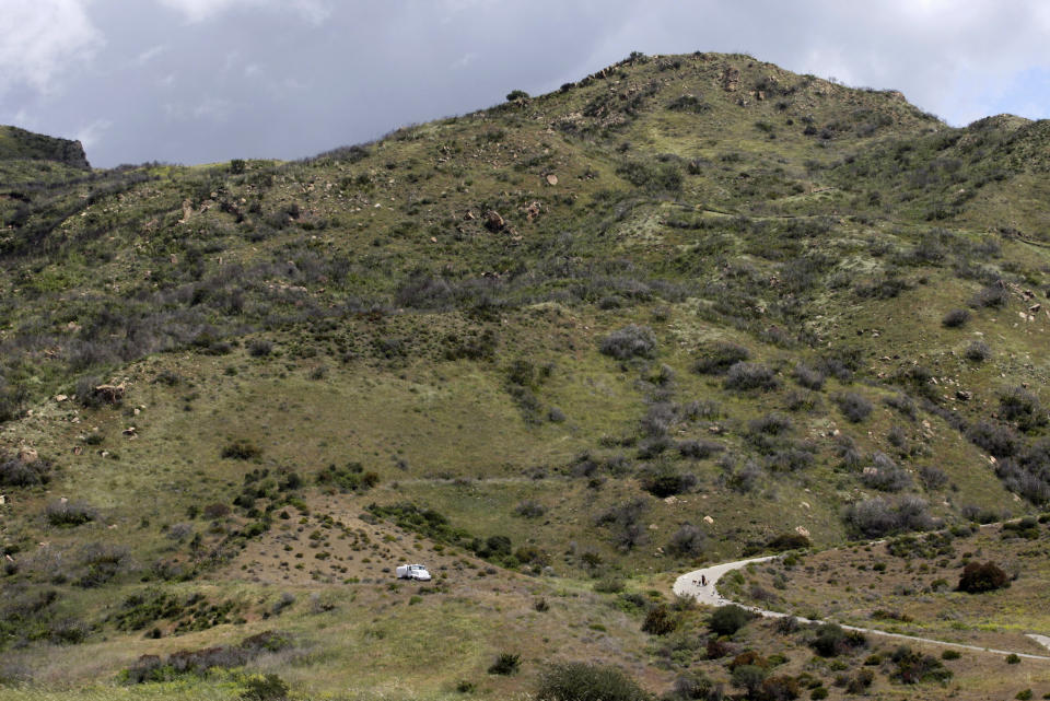 FILE - In this April 8, 2009, file photo, is the site of a proposed development by U2 guitarist The Edge is seen in Malibu Calif. A plan by U2 guitarist The Edge to build a cluster of mansions on a ridgeline above Malibu appears dead, after California's highest court declined to consider his last-ditch appeal. The musician, whose real name is David Evans, staged a 14-year legal fight to build five eco-friendly homes dubbed Leaves in the Wind in an undeveloped section of the Santa Monica Mountains west of Los Angeles. The state Supreme Court decided last week not to review a lower court ruling that denied approval to build on the land after the Sierra Club sued to block construction. (AP Photo/Damian Dovarganes, File)