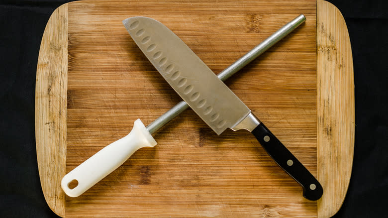 Knife and honing steel on a wood cutting board