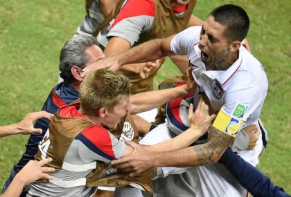 USA's Clint Dempsey celebrates with teammates during his team's draw against Portugal. (AFP)