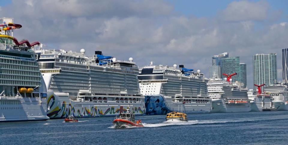 Lifeboats escorted by the U.S. Coast Guard bring sick crew members into PortMiami from cruise ships anchored off the coast on Monday, March 30, 2020, in Miami.