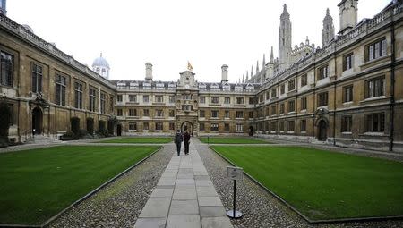 People walk through Clare College at Cambridge University in eastern England October 23, 2010. REUTERS/Paul Hackett