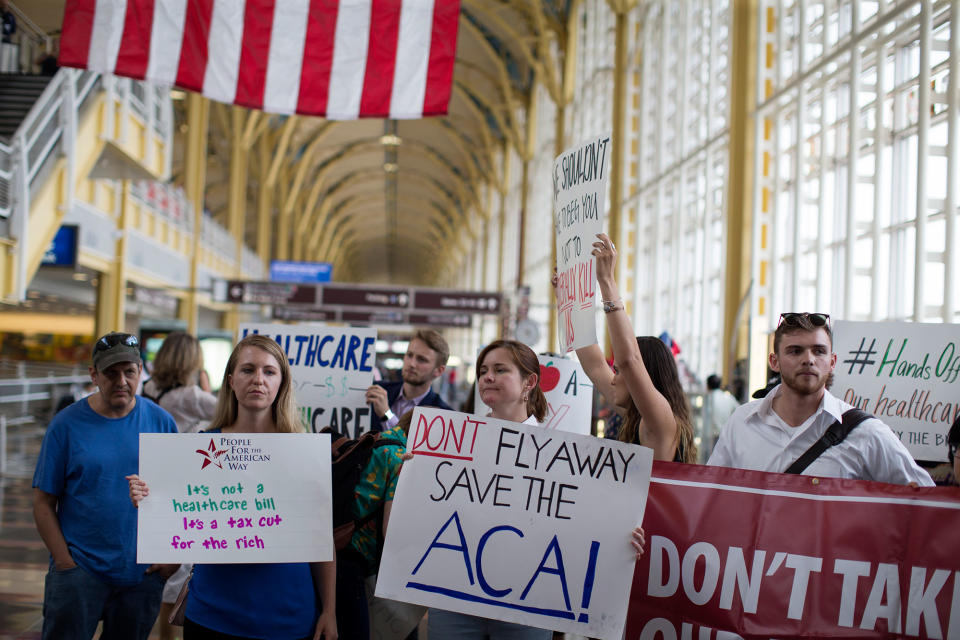 <p>Protesters greet senators leaving Ronald Regan Washington National Airport in Terminal B on June 22, 2017 in Washington. People came out to voice their views on the upcoming Healthcare vote on Capital Hill maybe as soon as next week. (Photo:Tasos Katopodis/Getty Images) </p>