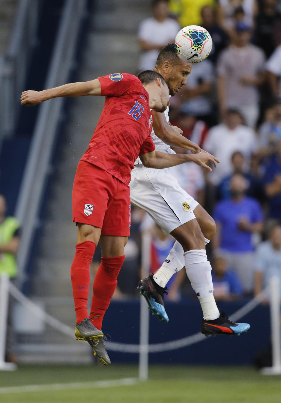 U.S. defender Daniel Lovitz (16) and Panama defender Francisco Palacios go for a head ball during the first half of a CONCACAF Gold Cup soccer match in Kansas City, Kan., Wednesday, June 26, 2019. (AP Photo/Colin E. Braley)