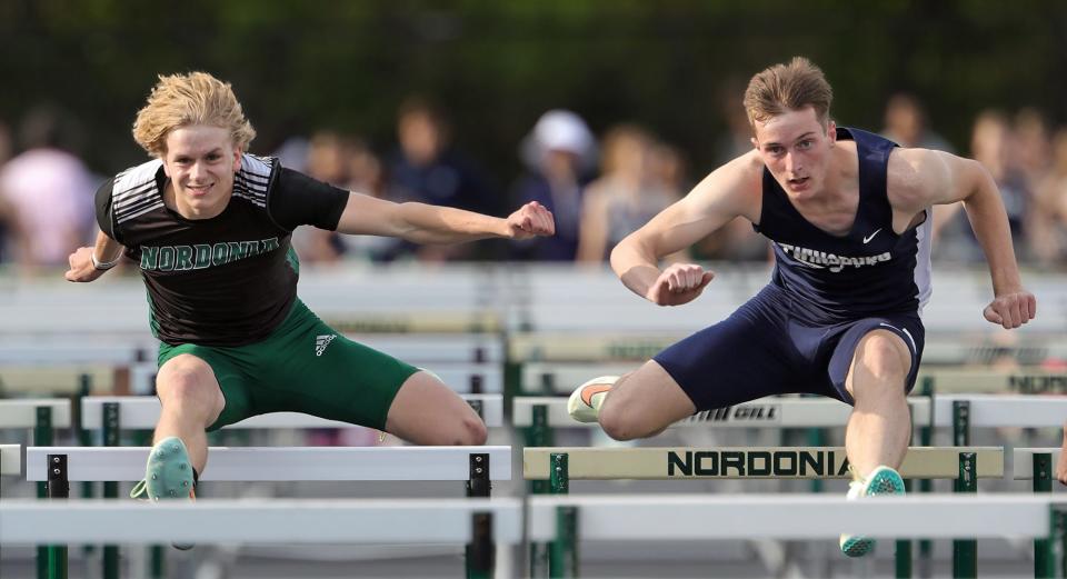 Nordonia's Matthew Hayes, left, and Twinsburg's Josh Mikulka compete in the boys 110 meter hurdles during the Division I district track meet at Nordonia High School on Friday.