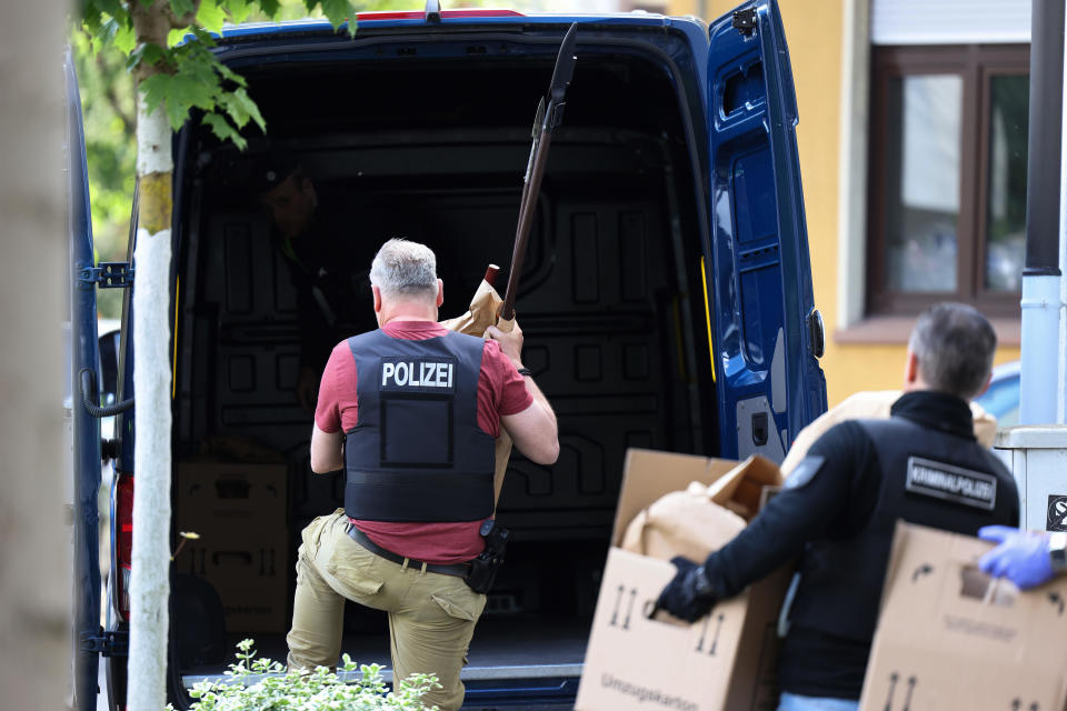 Police officers carry evidence from a suspect's home in Essen, Germany, May 12, 2022, in North Rhine-Westphalia state. A 16-year-old boy was taken into custody on suspicion of planning attacks against at least one school in the city. / Credit: David Young/picture alliance/Getty