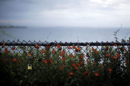 Locks hang on a fence along the Cliff Walk in Newport, Rhode Island July 14, 2015. REUTERS/Brian Snyder