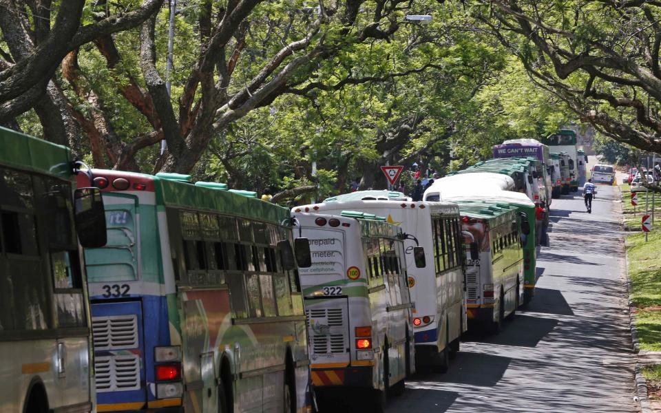 Mourners wait in buses at the entrance of the Union Buildings where former South African President Mandela lies in state in Pretoria