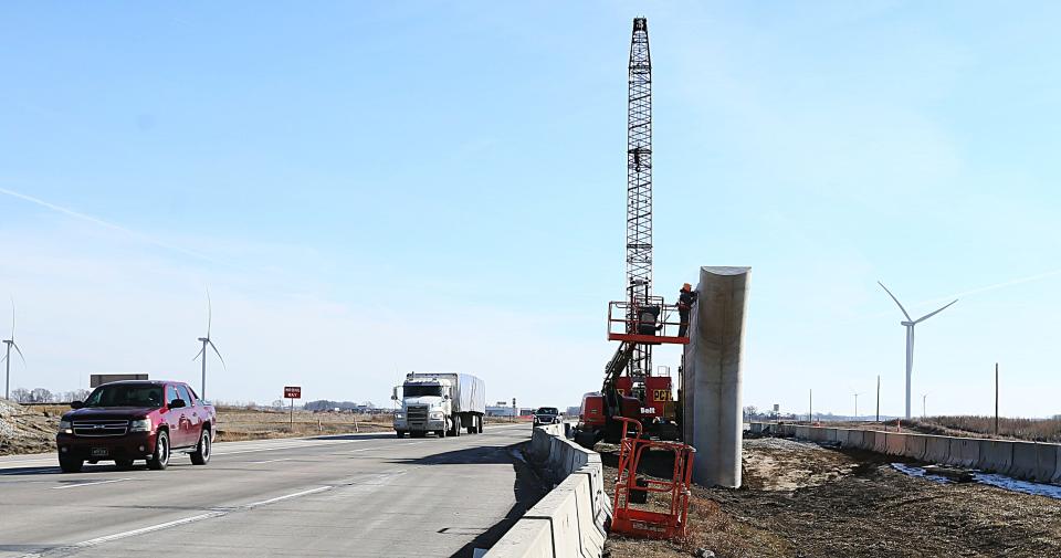 Constriction workers work on a new flyover bridge over HWY -30 between Ames and Nevada Monday, Feb. 19, 2024, near Ames, Iowa.