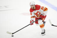 Calgary Flames center Elias Lindholm (28) skates with the puck during the overtime of an NHL hockey game against the Washington Capitals, Saturday, Oct. 23, 2021, in Washington. The Flames won 4-3 in overtime. (AP Photo/Nick Wass)